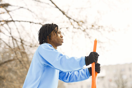 African american man doing exercise on winter day