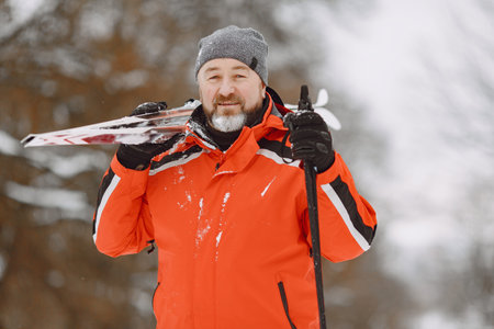 Senior man skiing cross-country in a forest