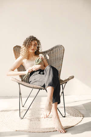 Portrait of a beautiful young woman with flowers. Tenderness and aroma.の写真素材