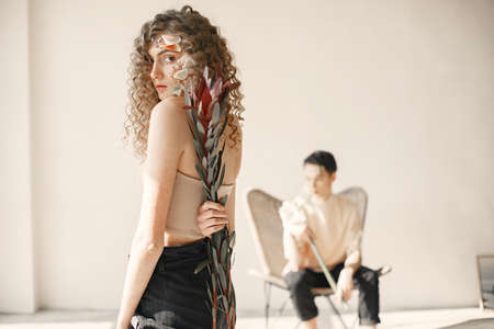 Portrait of a beautiful young woman with flowers. Tenderness and aroma.の写真素材