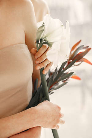 Close up picture of girls hands with flowers.の写真素材