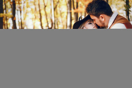 Elegant couple in a sunny autumn parkの写真素材