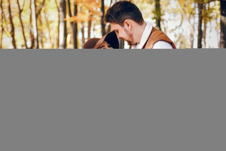 Elegant couple in a sunny autumn parkの写真素材