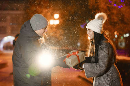 Young couple outdoor in night street at winter timeの写真素材