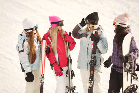 Group of girls spend time together skiing in mountainsの写真素材