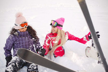 Group of girls spend time together skiing in mountainsの写真素材