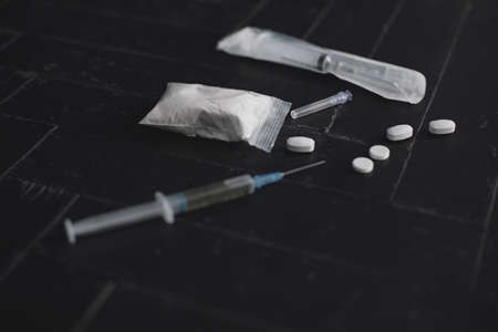 Syringe and pills on dark background close upの写真素材