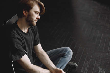 Male druggy sitting relaxed after taking doseの写真素材