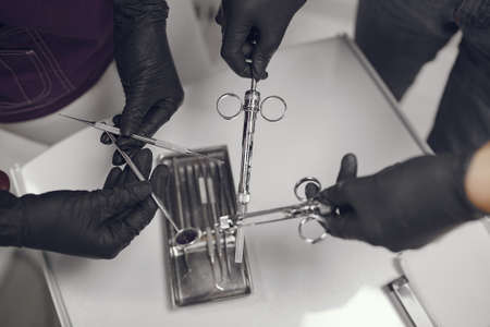 Dental tools in a dentist handの写真素材
