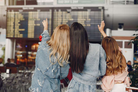Three beautiful girls standing by the airportの写真素材