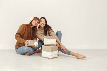 Beautiful girls have fun in a studio with presentsの写真素材