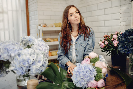 Florist in a flower shop making a bouquet