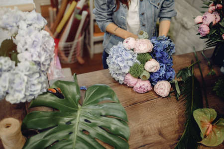 Florist in a flower shop making a bouquetの写真素材