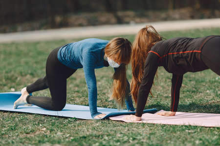 Cute girls doing yoga in a masksの写真素材