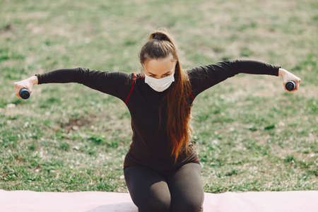Cute girl doing yoga in a summer parkの写真素材