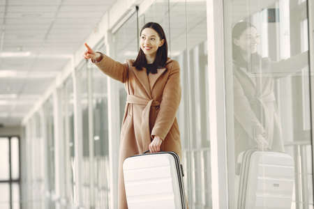 Woman with suitcase at the airportの写真素材