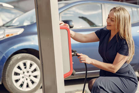 Elegant woman standing on a gas stationの写真素材