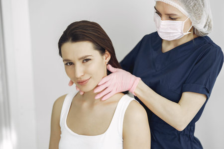Woman with a doctor in cosmetology studio