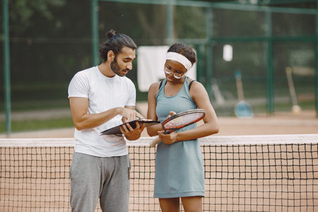 Two tennis players reading a rules before the match