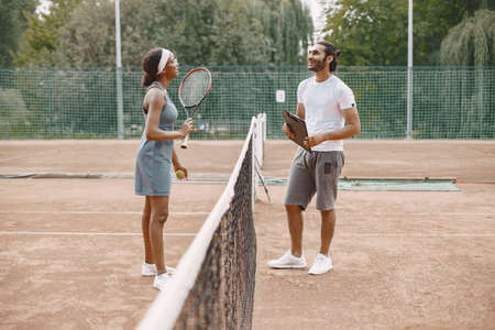 Two tennis players talking on a tennis court before the matchの写真素材