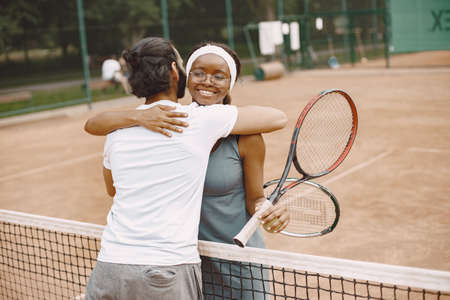 Two tennis players hugging after the matchの写真素材