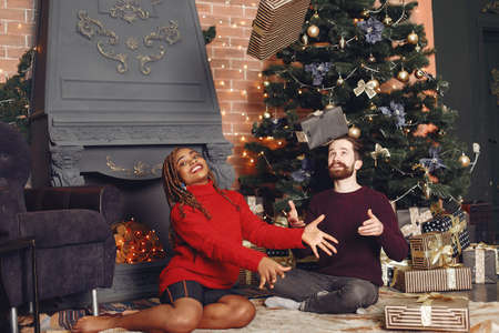 Mixed couple having fun and spending Christmas togetherの写真素材