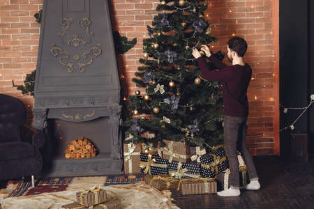 Bearded guy at home in a Christmas decorationsの写真素材