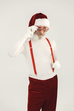 Modern santa claus in sunglasses on a white background