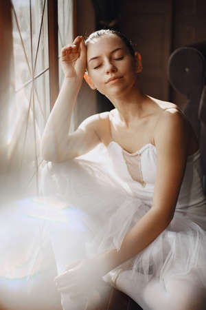 Ballerina posing in front of white backgroundの写真素材