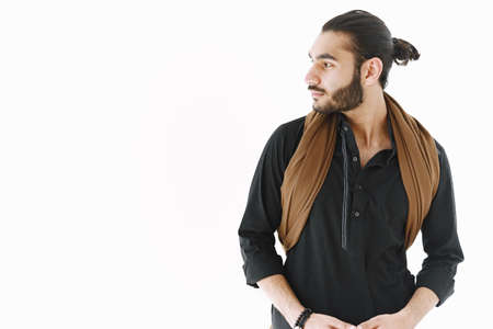 Young muslim man posing casually over white wall. Studio, isolated.の写真素材