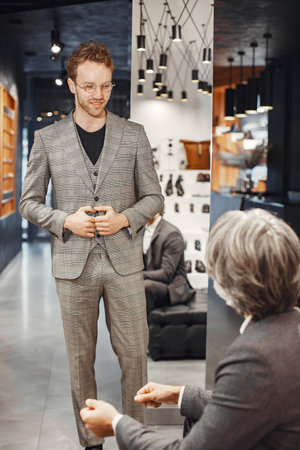 Senior man choosing a new suit in a store