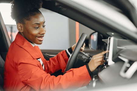 Young african american woman in car salon