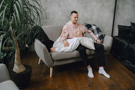 Young romantic gay couple spending day cuddlingの写真素材