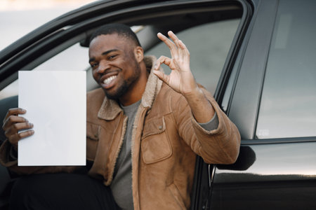 Black man with happy face impression holding sheet of paper