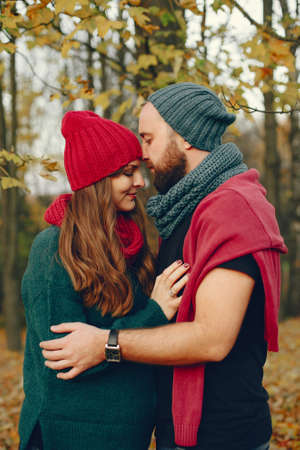 Elegant couple spend time in a autumn parkの写真素材