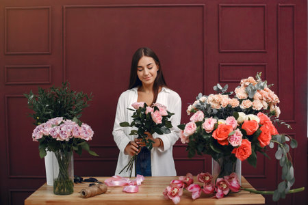 Frorist makes a beautiful bouquet in a studioの写真素材