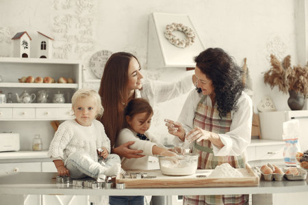 Family cook the dough for cookies