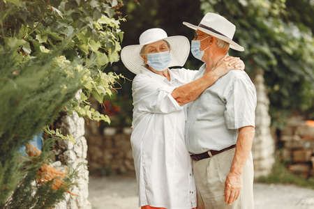 Beautiful old couple spend time in a summer gardenの写真素材
