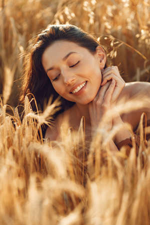 Stylish woman spending time in a summer fieldの写真素材