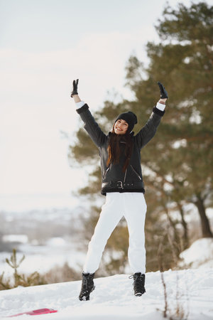 Outdoor photo of fashionable female in winter park