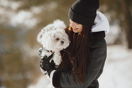 young woman hugging her dog close up outdoors