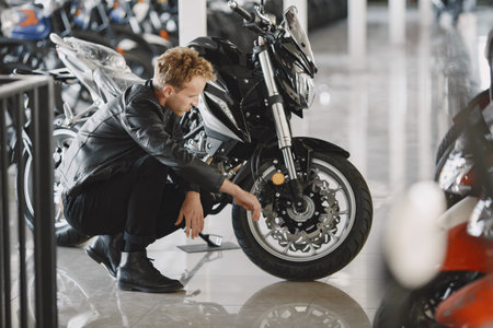 Handsome man choosing a motorcycle to buy