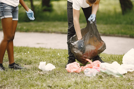 Young volunteers cleaning the rubbish in parkの写真素材
