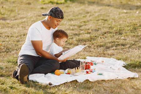 Father and son having fun in summer parkの写真素材