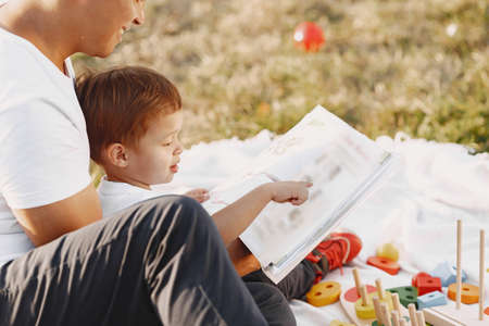 Father and son having fun in summer parkの写真素材