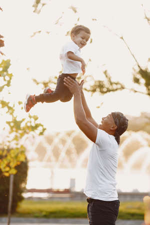 Asian family in a park. Man in a white t-shirt.の写真素材