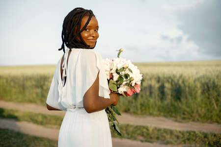Portrait of beautiful black woman with flowersの写真素材