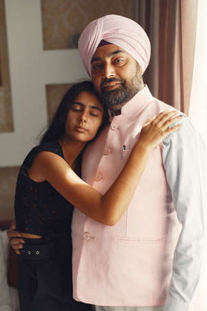 Portrait of Indian sikh man in turban with daughterの写真素材