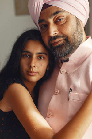 Portrait of Indian sikh man in turban with daughterの写真素材