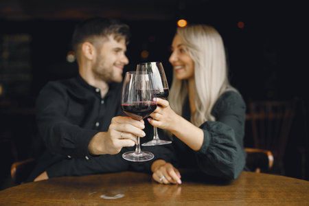 Romantic couple drinking wine at restaurantの写真素材